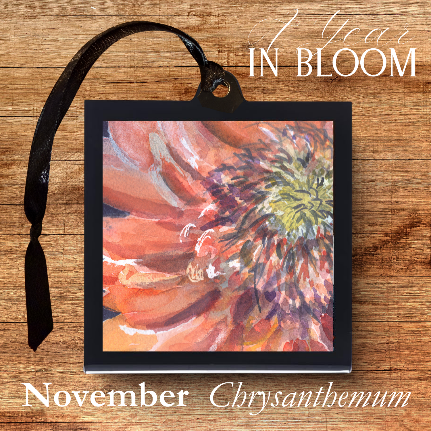 Framed artwork of a chrysanthemum with '1 Year in Bloom' text on a wooden background