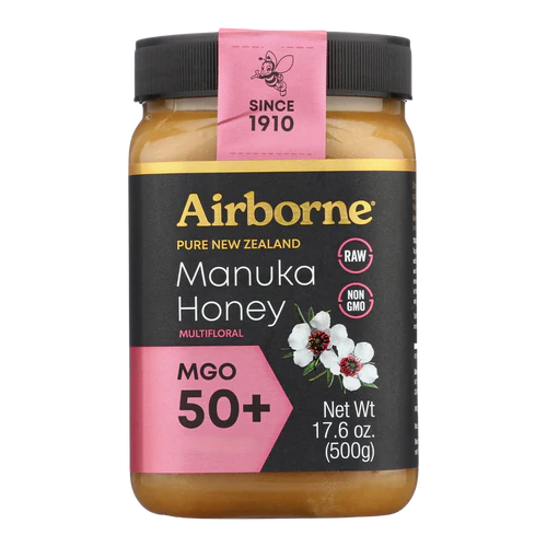 Airborne Manuka Honey jar with black lid and pink label on a white background