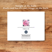 Card with a pink rose illustration on a wooden surface