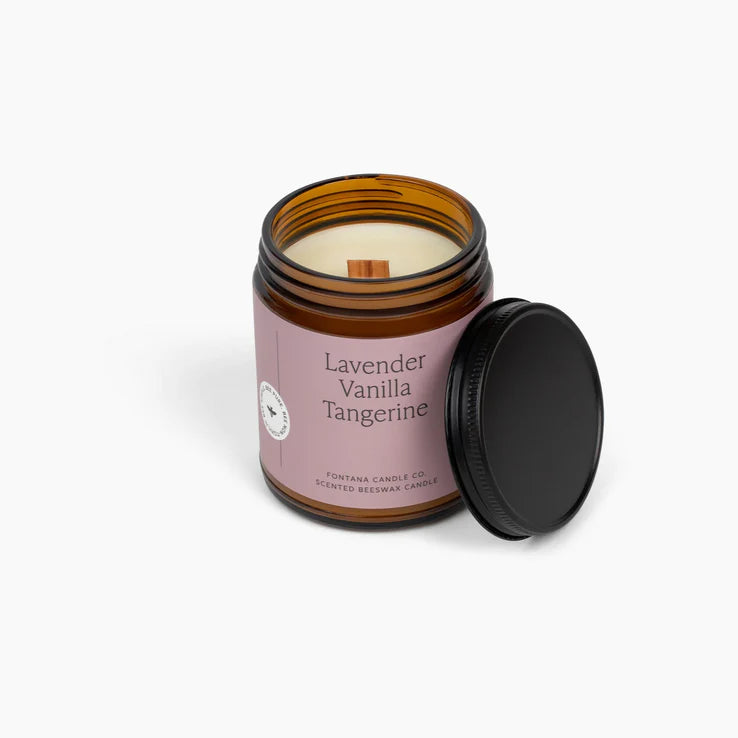 Lavender Vanilla Tangerine Candle in an amber jar with a pink label on a white background