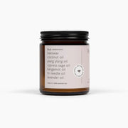 Candle jar with a label on a white background