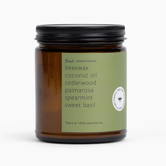 Candle jar with a green label on a white background
