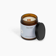 Sea Salt candle in a amber jar with a black lid on a white background
