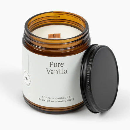 Pure Vanilla scented candle in a glass jar with a black lid on a white background