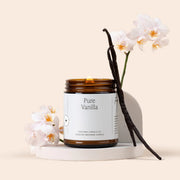 Pure Vanilla candle with vanilla beans and orchids on a beige background