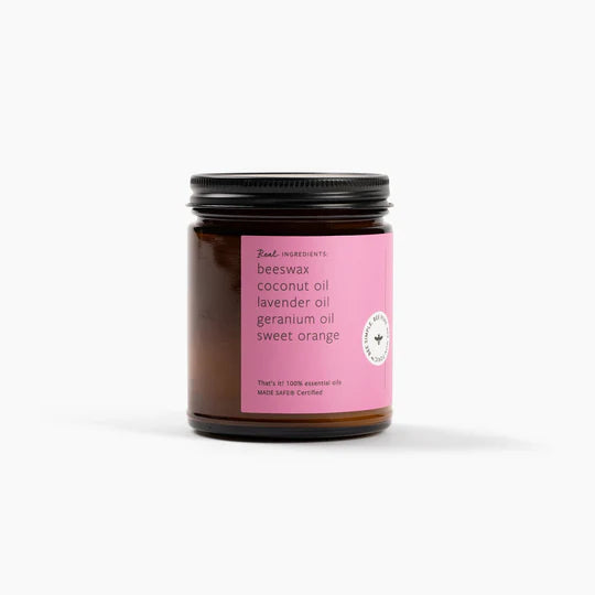 Jar of candle with pink label on a white background