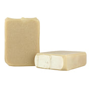 Two bars of beige soap on a white background