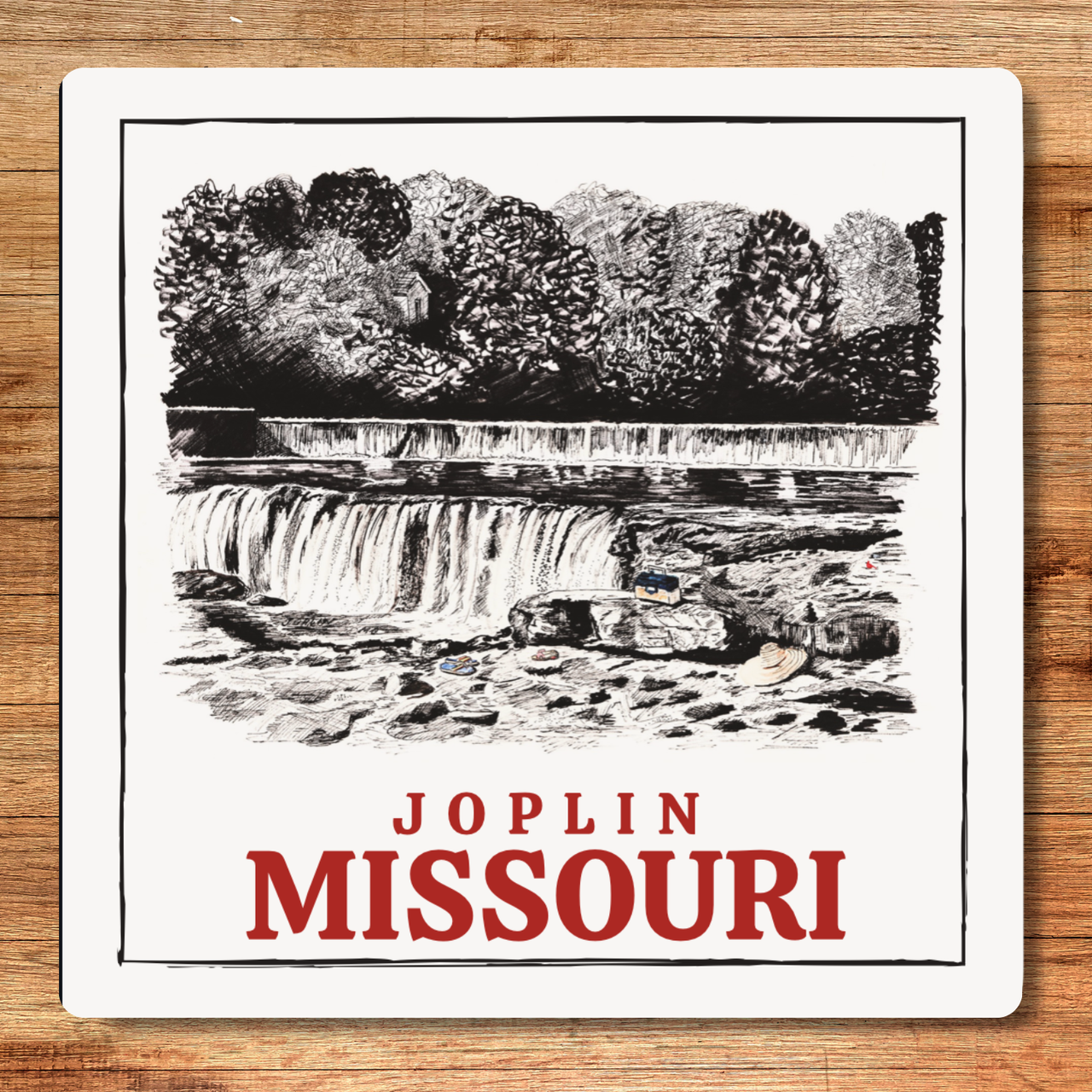 Illustration of a waterfall with 'Joplin Missouri' text on a wooden surface