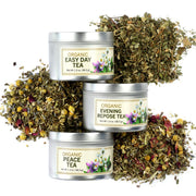Three tins of organic tea with dried herbs on a white background