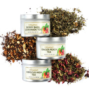 Three tins of organic tea with their respective labels and loose tea leaves on a white background