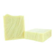 Two pale yellow rectangular bars of soap standing upright on a plain white background.