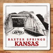 Illustration of a bridge with 'Rainbow Bridge' and 'Baxter Springs Kansas' text on a wooden surface.