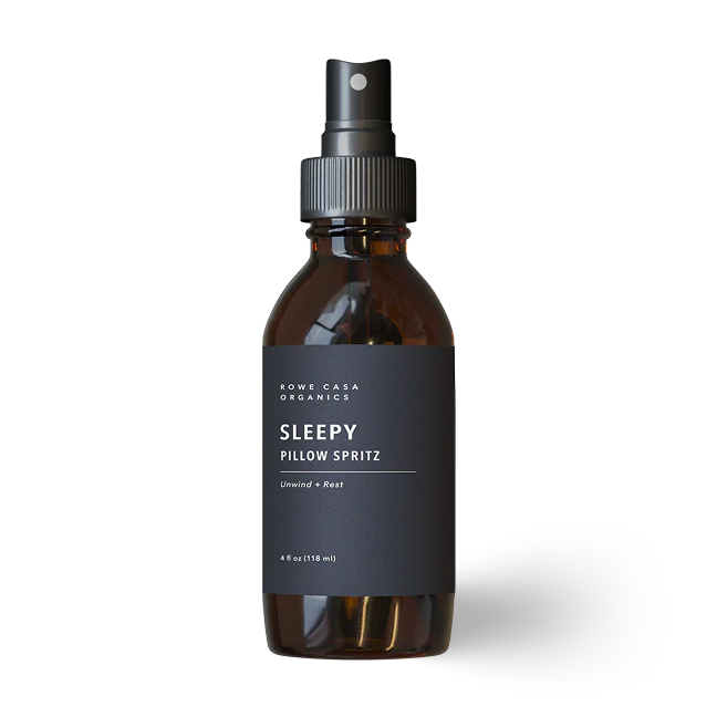 Brown glass bottle with black label "Sleepy Pillow Spritz" on a white background