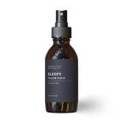 Brown glass bottle with black label "Sleepy Pillow Spritz" on a white background