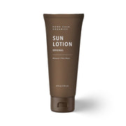 Brown tube of Rowe Casa Organics Sun Lotion on a white background