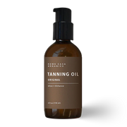 Brown bottle of all-natural protective tanning oil on a white background