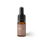 Brown essential oil bottle with dropper labeled 'Early Bump on a white background