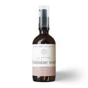 Bottle of all-natural feminine wash on a white background