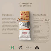 A nutrition information graphic for a Strawberry Shortcake protein bar. The layout features a clean beige background with the product name at the top, a central image of a sliced protein bar with a few strawberry pieces visible, a wrapped protein bar package, and a detailed ingredients list on the left and nutrition facts on the right.