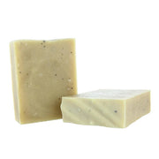 Two rectangular bars of handmade soap in a light beige color with small dark specks, shown on a plain white background.