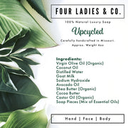 A square product label for Four Ladies & Co. Upcycled soap, featuring a white background with green tropical leaves on the left side and black and green text detailing the ingredients and product type.