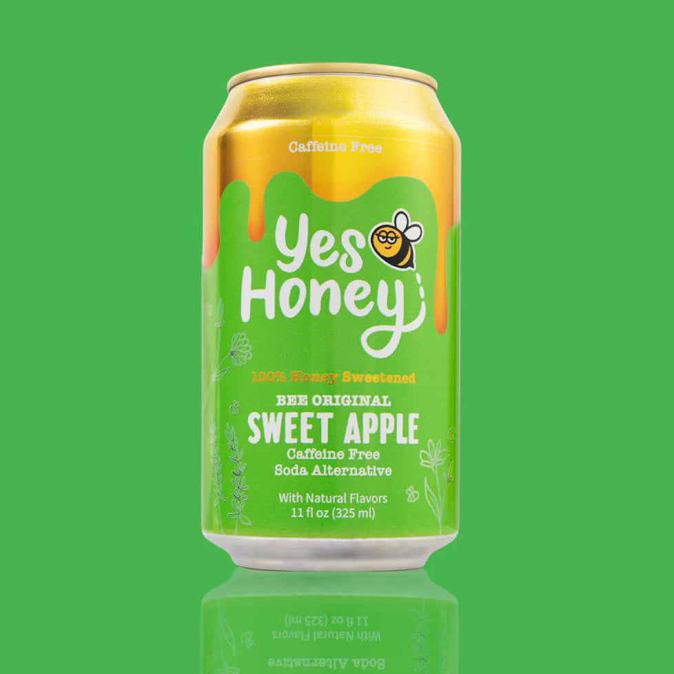 Gold and green can of 'Yes Honey' Sweet Apple soda on a green background