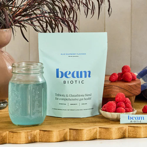 beam BIOTIC package with a jar of blue liquid and raspberries on a wooden surface