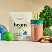 beam Kids All-in-One Superpowder package with a cup and snacks on a light background