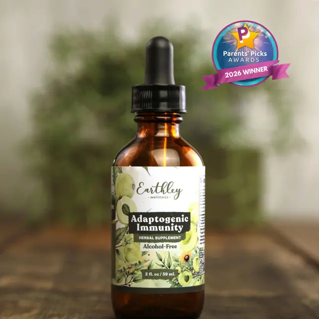 Earthley Adaptogenic Immunity supplement bottle with dropper on a blurred natural background