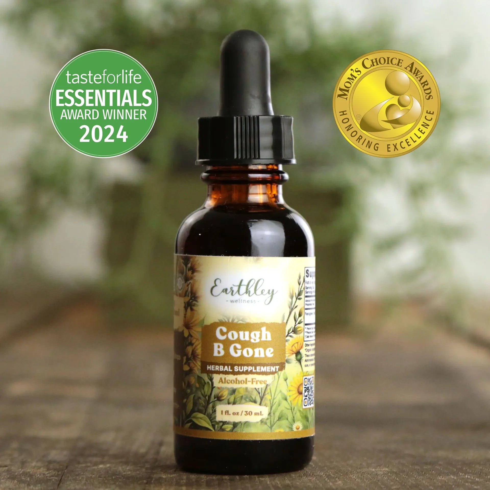 Bottle of Earthley Cough B Gone supplement with awards on a wooden surface