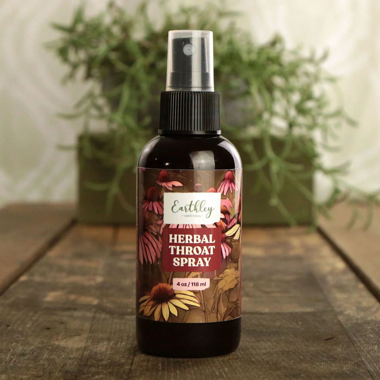 Herbal throat spray bottle with floral label on a wooden surface