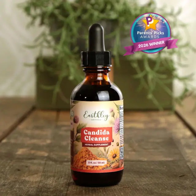 Bottle of Earthley Candida Cleanse supplement with a dropper on a wooden surface, featuring a 'Parents' Picks Award' badge.
