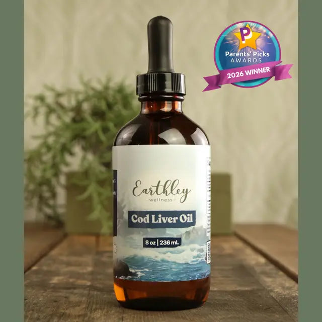 Bottle of Earthley Cod Liver Oil with a dropper on a wooden surface, featuring a 'Parents' Picks Award' badge.