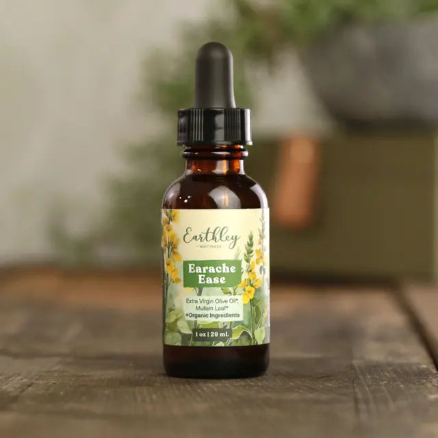 Bottle of Earthley Earache Ease on a wooden surface with a blurred background