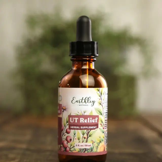 Bottle of Earthley Wellness UT Relief herbal supplement with a dropper on a blurred natural background
