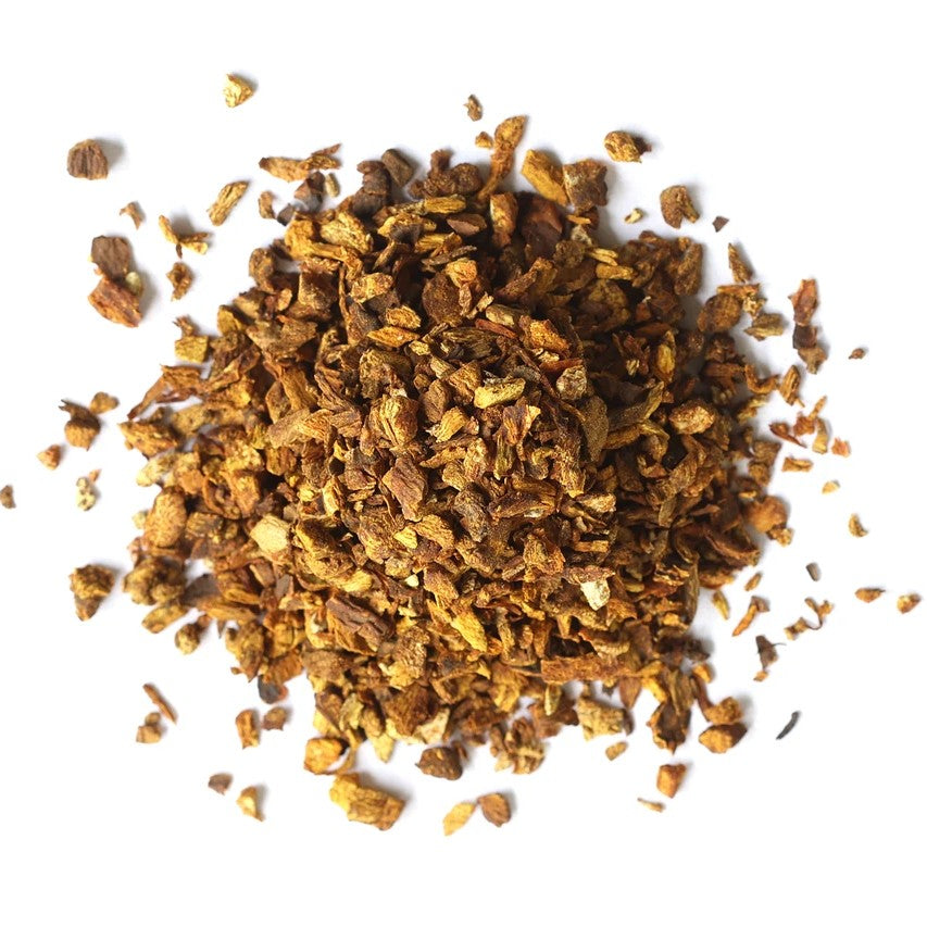 A pile of dried, shredded brown herbal or botanical roots and bark pieces scattered on a plain white background.