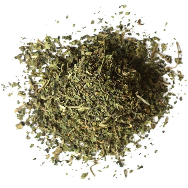 Mixture of dried nettle herbs on a white background