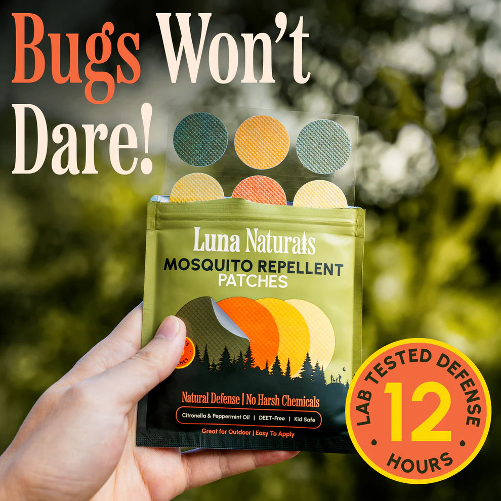 Luna Naturals mosquito repellent patches held by a hand with outdoor background