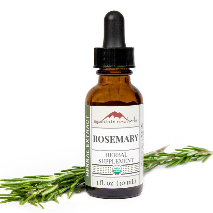 Bottle of Mountain Rose Herbs Rosemary Herbal Extract on a white background with rosemary sprigs.