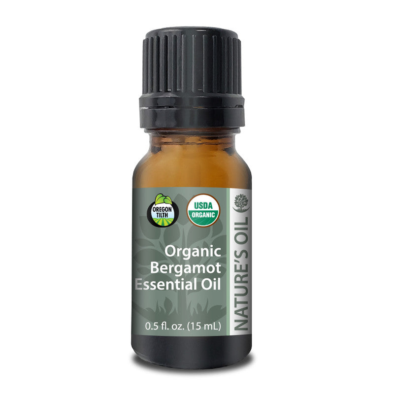 Bottle of Organic Bergamot essential oil with a black cap on a white background