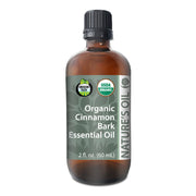 Bottle of Organic Cinnamon Bark Essential Oil with label on a white background