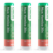 Three green and red Nux Vomica 30c Olois homeopathic product tubes on a white background