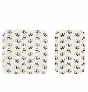 Two cream-colored mats with black panda pattern on a white background