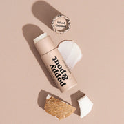 Lip balm with a coconut shell and 'Island Coconut' text on a beige background