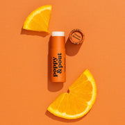 poppy pout Orange-flavored product with orange slices on an orange background