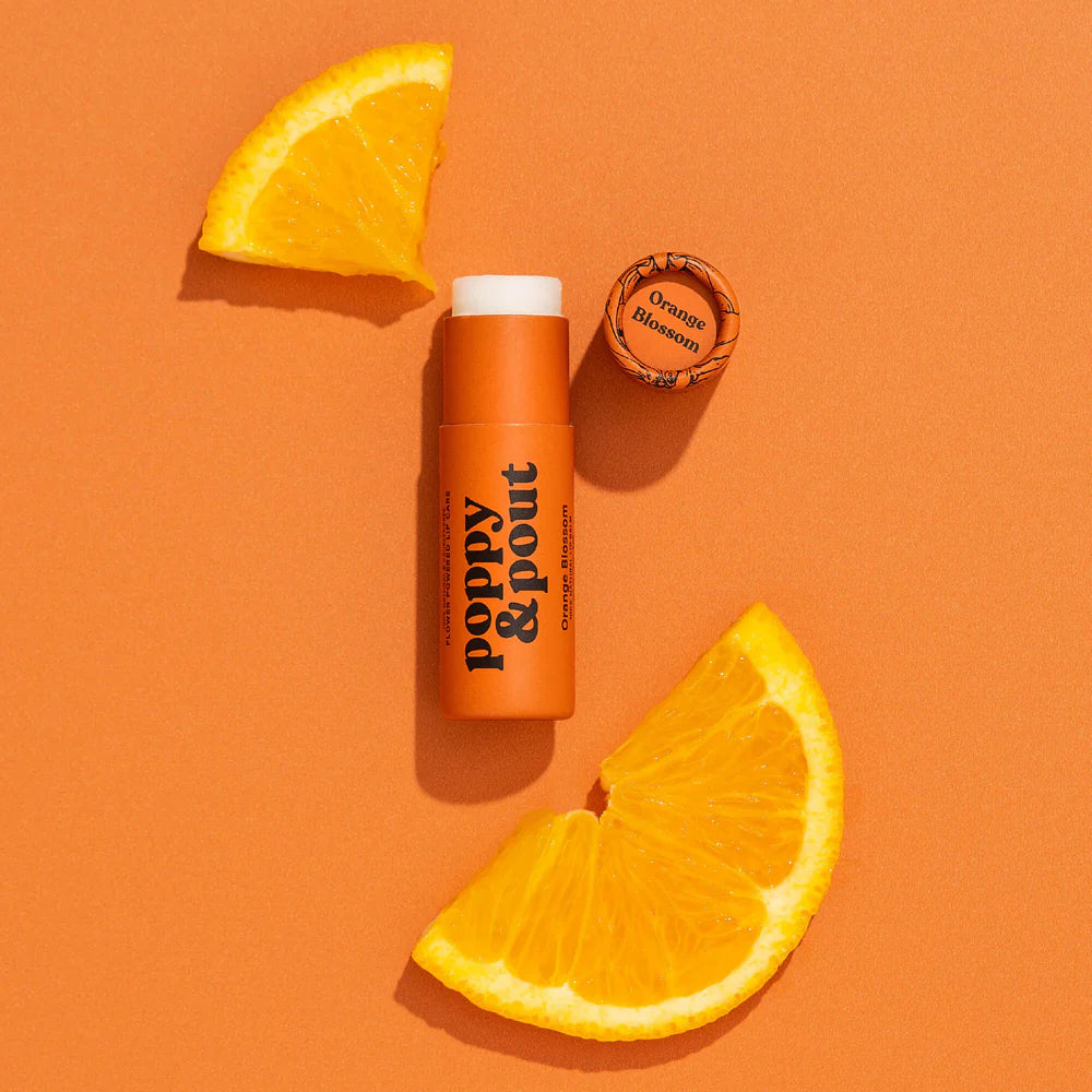 poppy pout Orange-flavored product with orange slices on an orange background