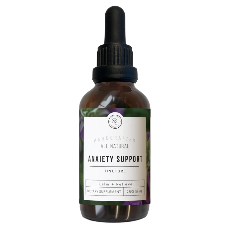 Bottle of anxiety support tincture with dropper on a white background