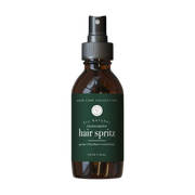 rowe casa Brown spray bottle labeled 'All-Natural Restorative Hair Spritz' on a white background