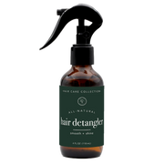 rowe casa Brown bottle of hair detangler with a black spray nozzle on a white background