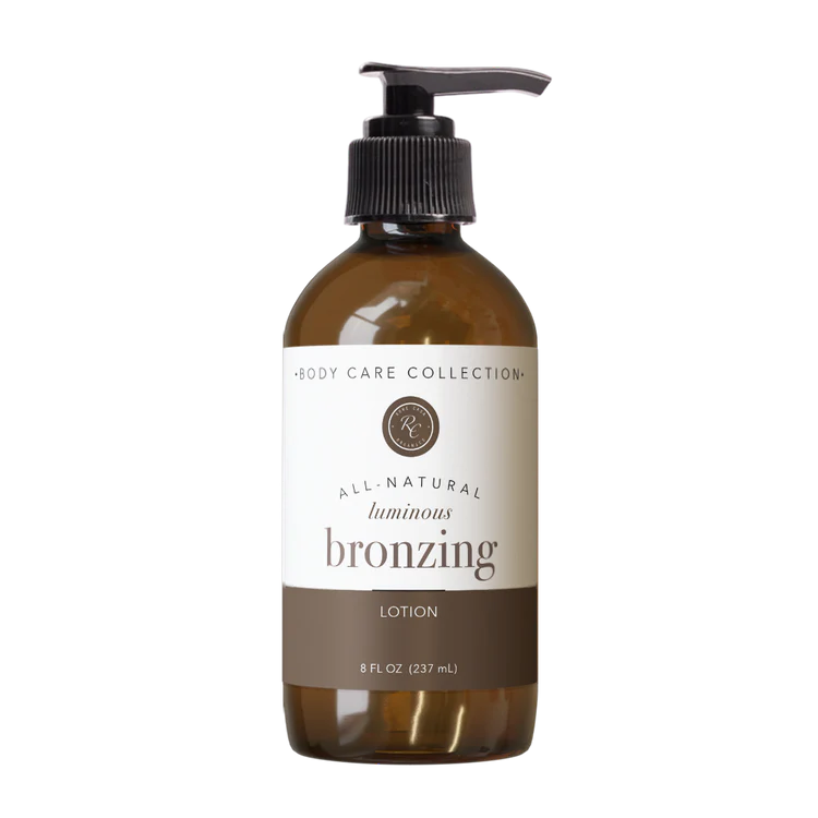 Brown bottle of all-natural luminous bronzing lotion with pump on a white background
